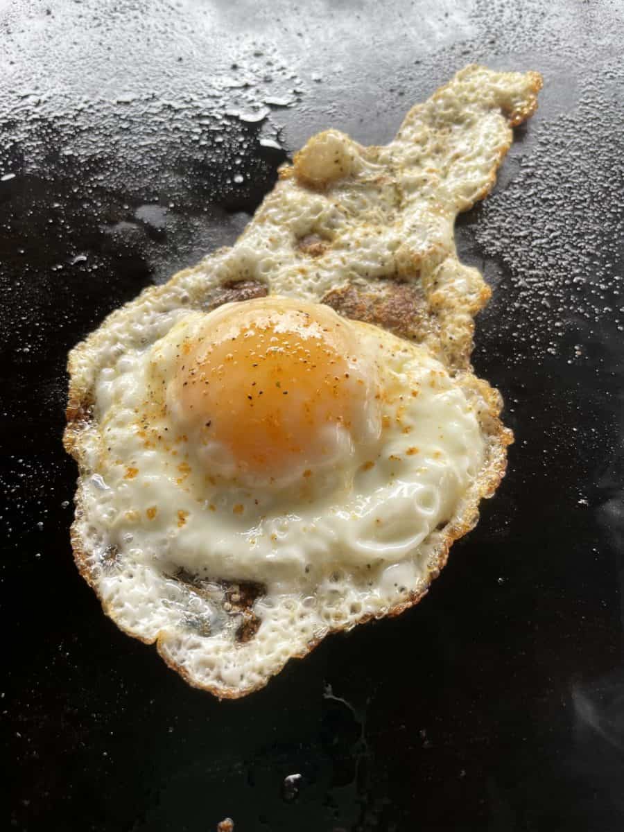 A Fully Cooked Fried Egg on a Blackstone Griddle.
