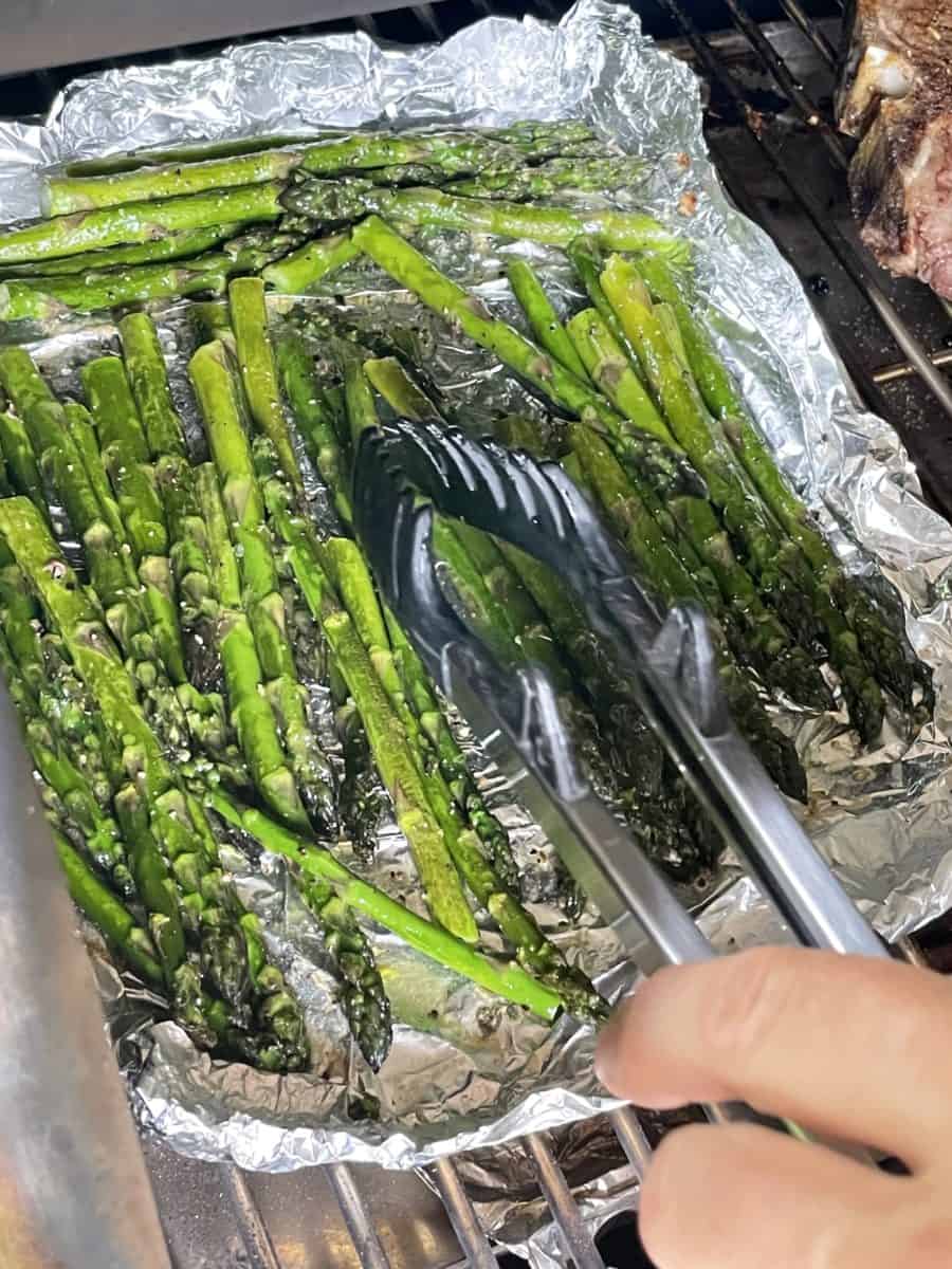 Tossing the Asparagus half way through smoking on a pellet grill.