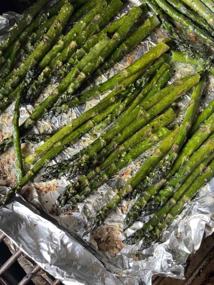 Smoked Asparagus on a piece of foil on a pellet grill.