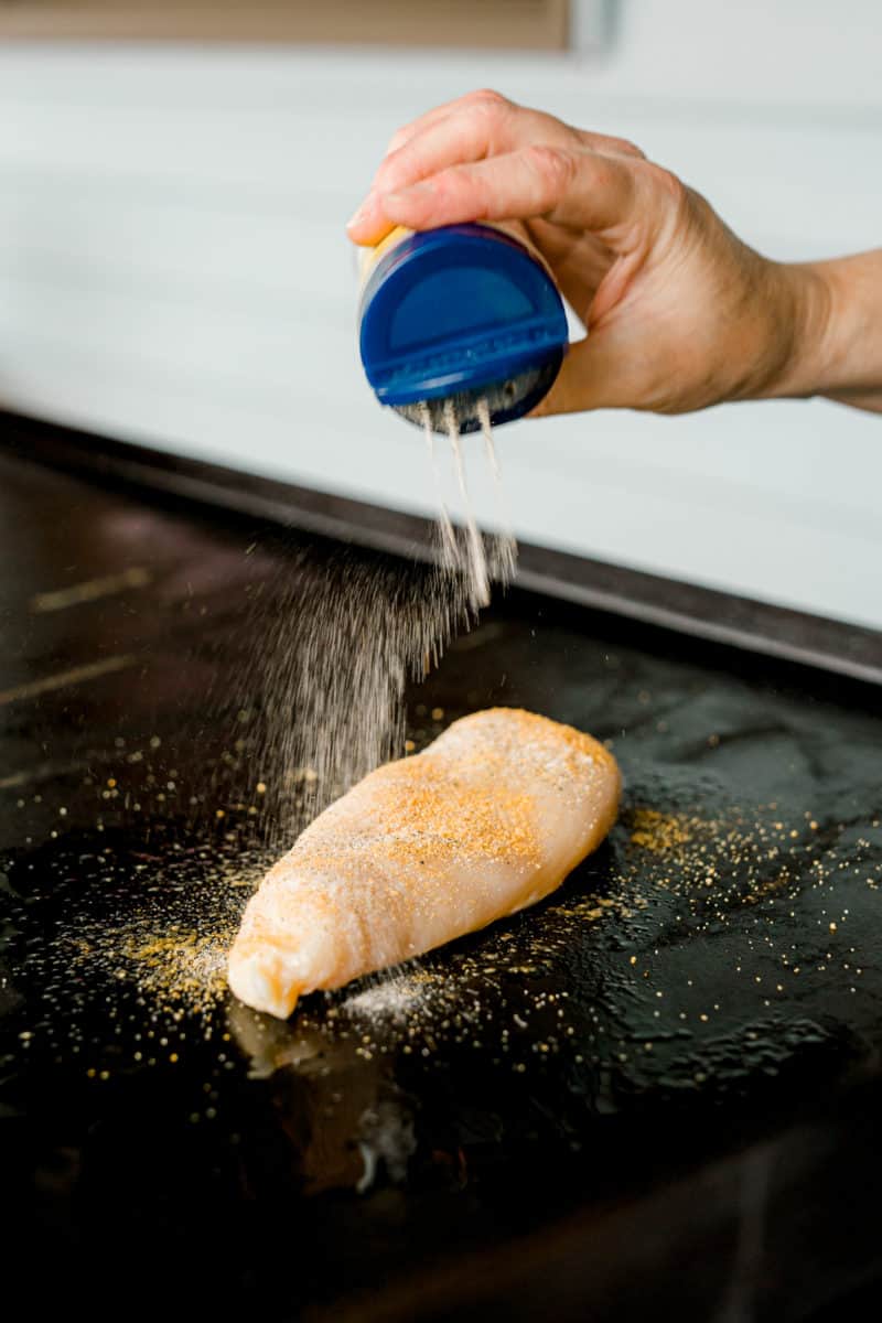 Seasoning a Chicken Breast that's on a Blackstone Griddle.