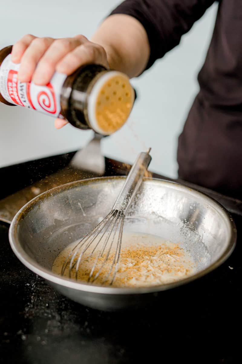 Sprinkling in some Lawry's Seasoned Salt to the White Sauce.