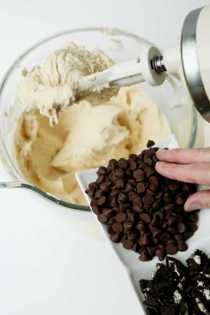 Adding Chocolate Chips, Chunks, and Oreo Pieces to the Cookie Batter.