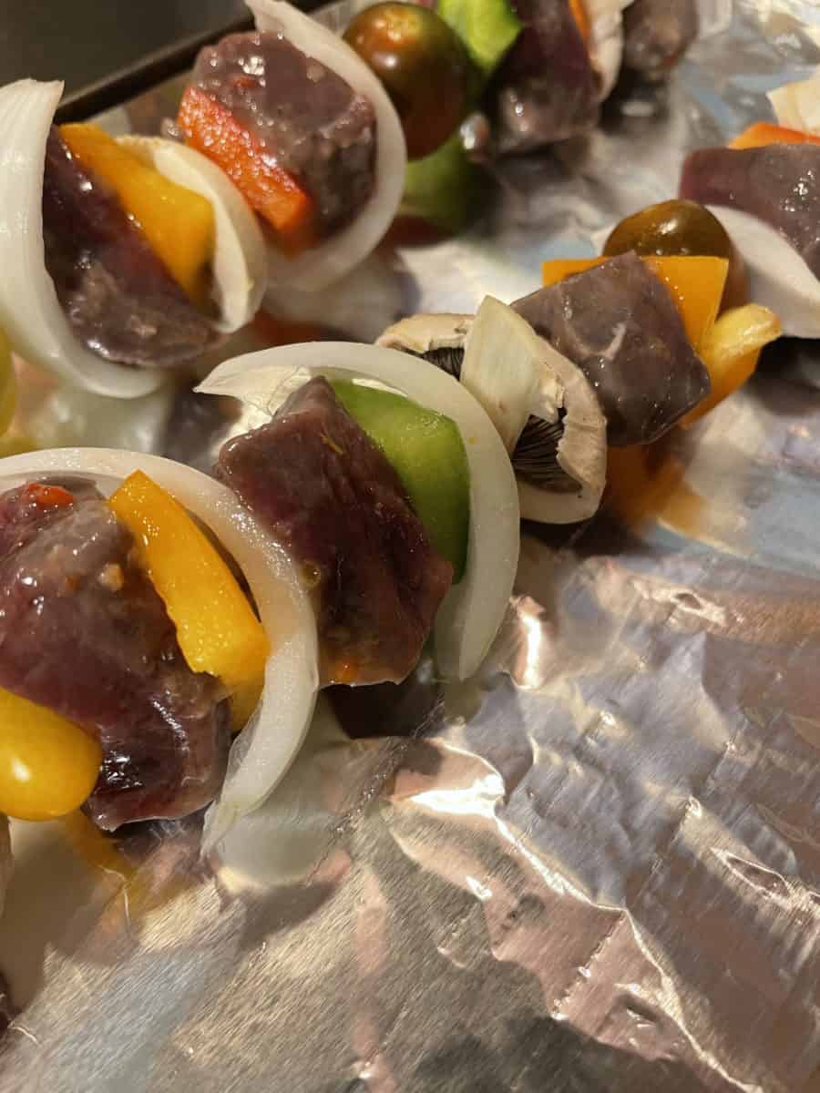 Fully assembled uncooked venison kabobs.