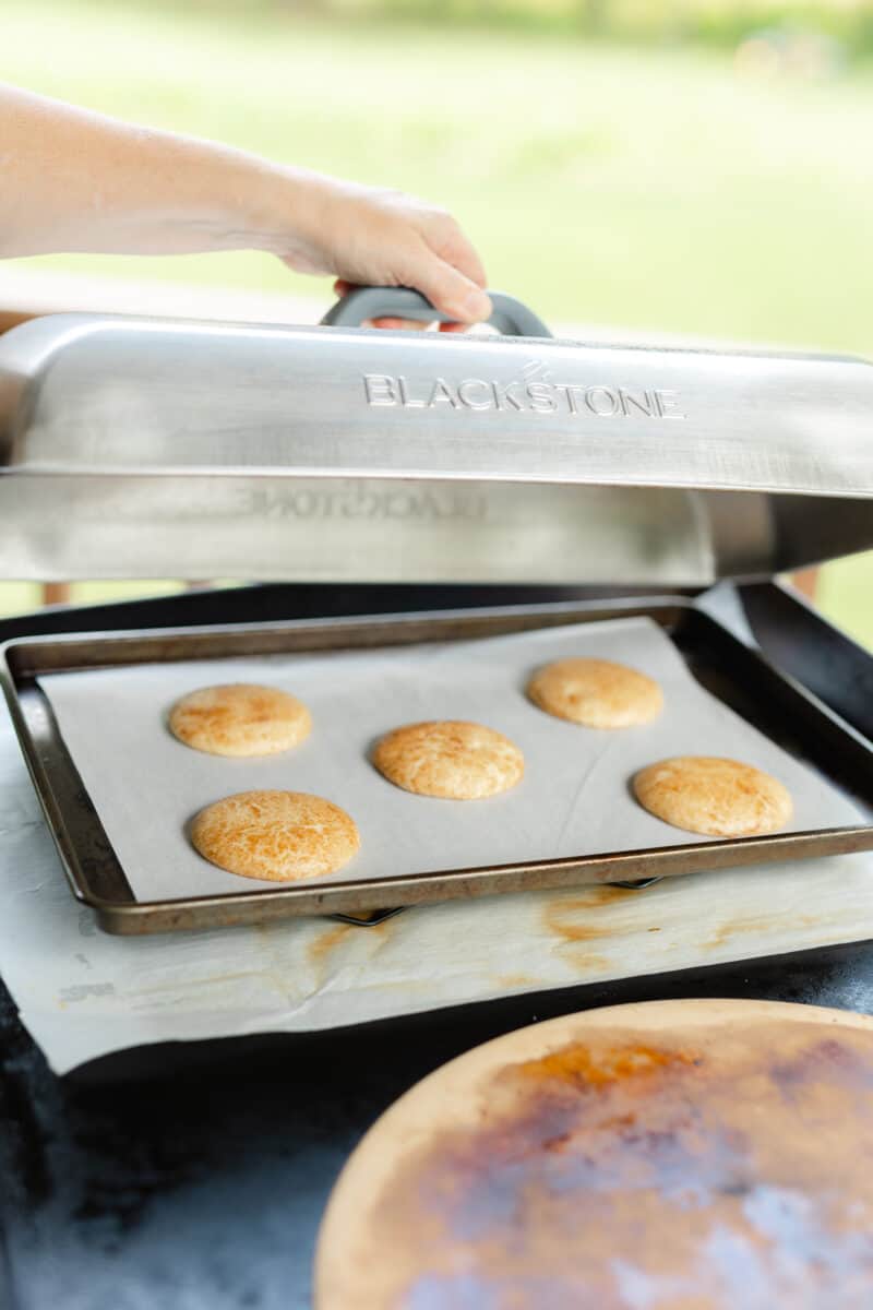 Place a Dome Lid overtop the baking cookies on the Blackstone Griddle.
