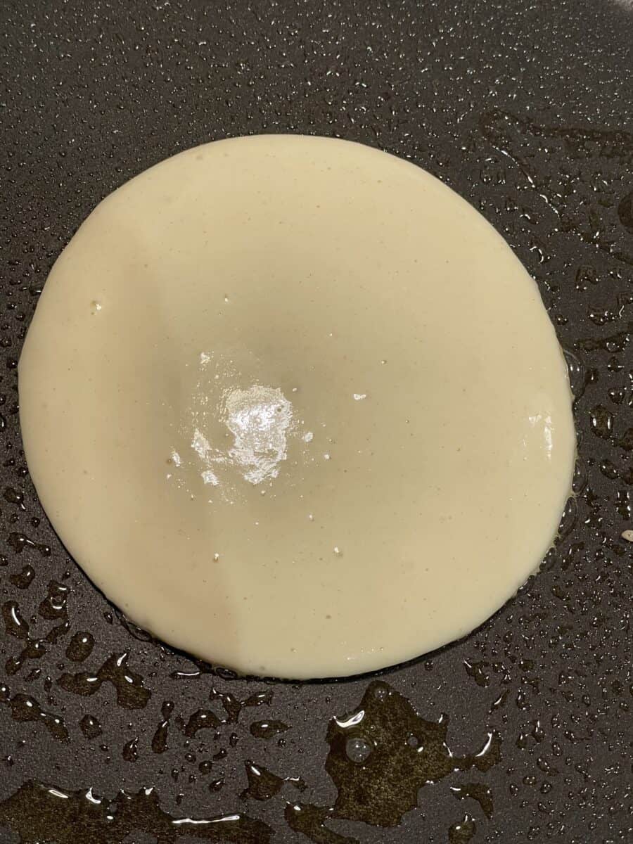 A pancake cooking on a greased Blackstone Griddle.