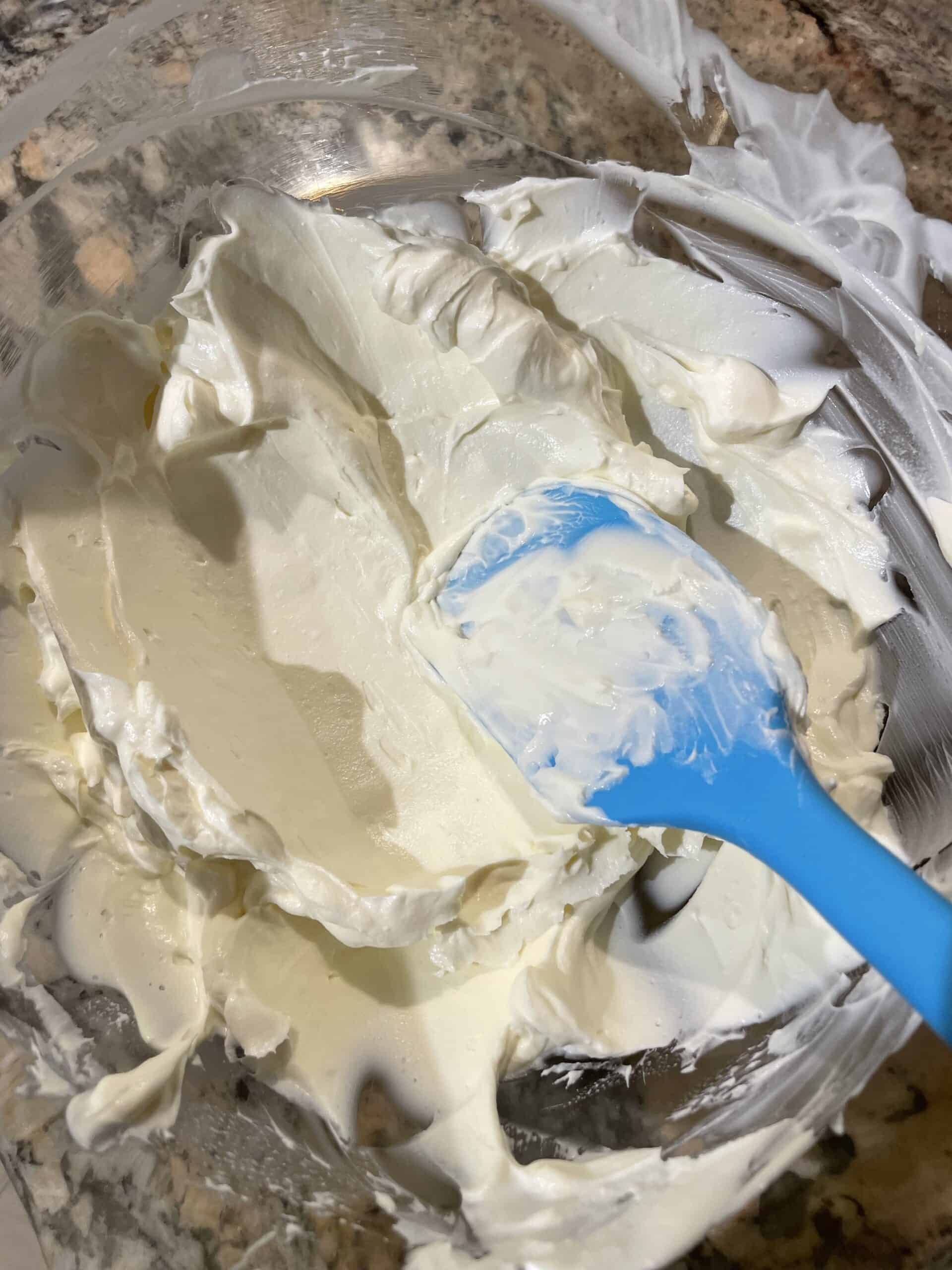 Mixing Sour Cream and Cream Cheese until smooth and creamy.