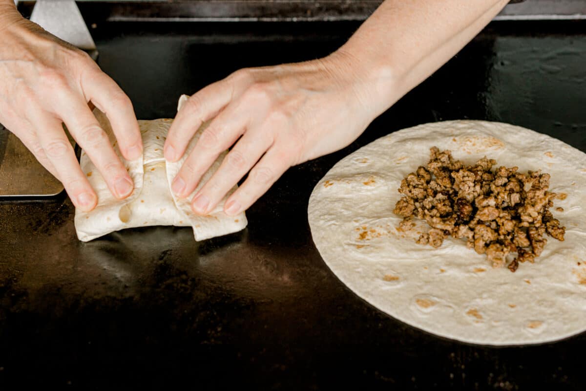 Flipping Over a Folded Burrito onto the Blackstone Griddle.