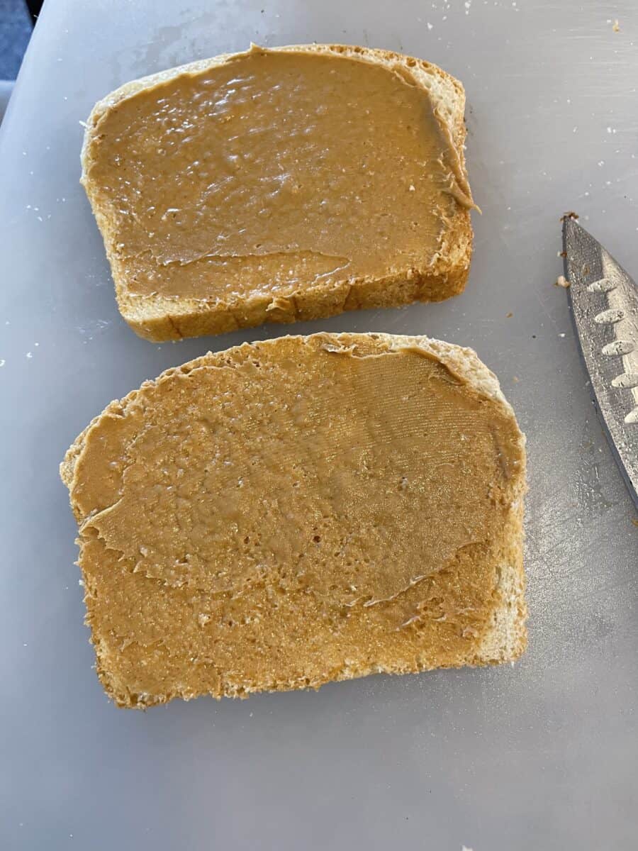 Peanut Butter Spread on 2 Slices of White Bread.