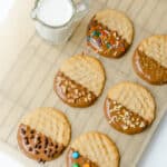 Peanut Butter Chocolate Dipped Cookies with an assortment of sprinkles.