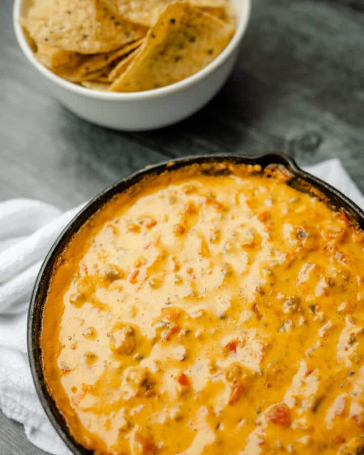 Smoked Queso Dip in a Cast Iron Pan with a side of Tortilla Chips.
