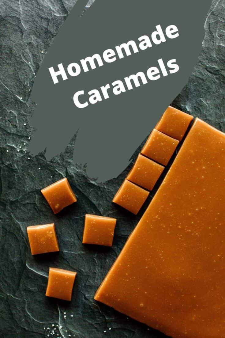 A slab of homemade caramel along with square pieces of caramel all on a board.