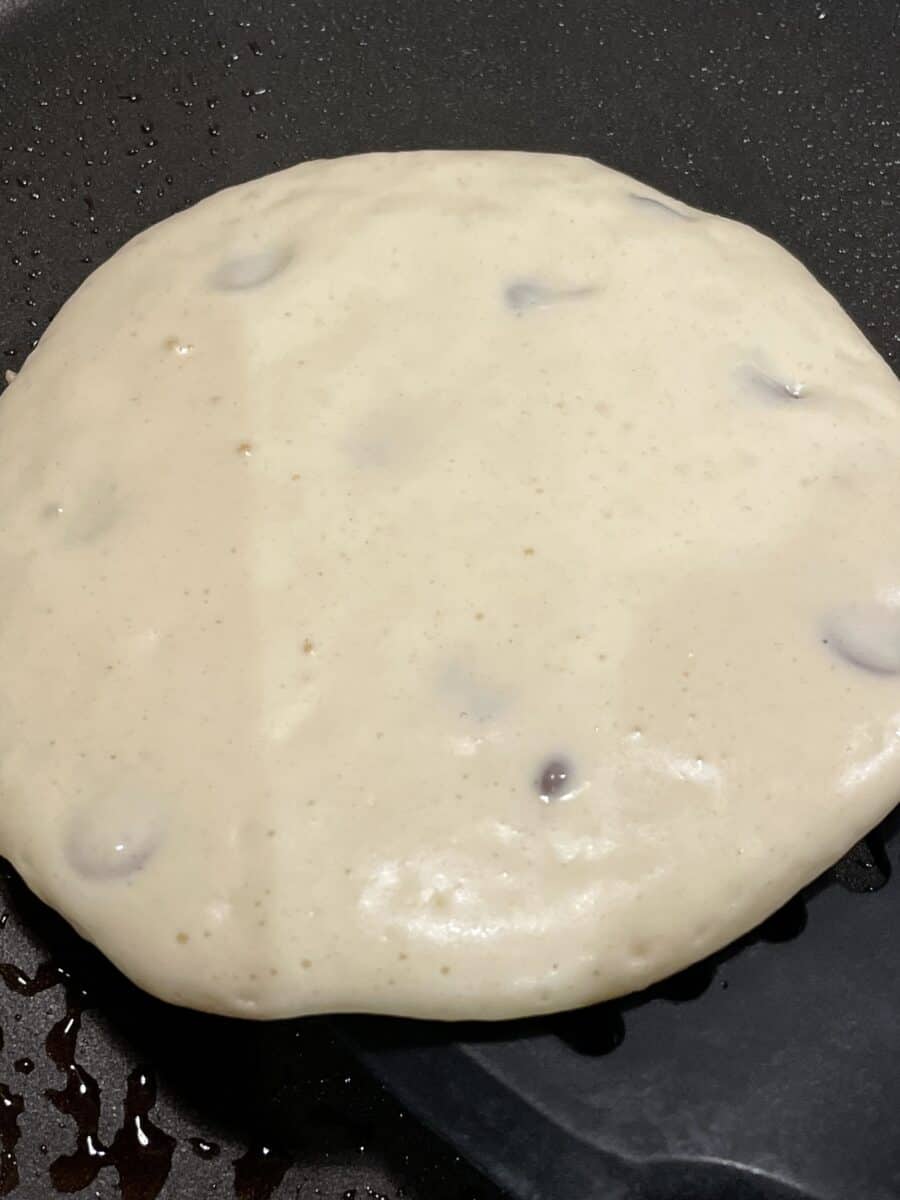 Blueberries Covered in Pancake Batter as the Pancake is Cooking on a Blackstone Griddle.