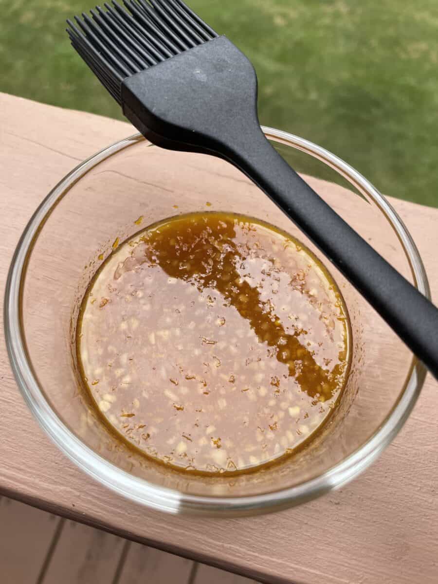 Homemade Orange Marinade in a Bowl with a Silicone Basting Brush.