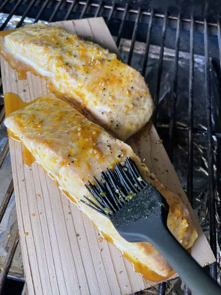 Using a Basting Brush to Apply a Layer of the Orange Marinade. 