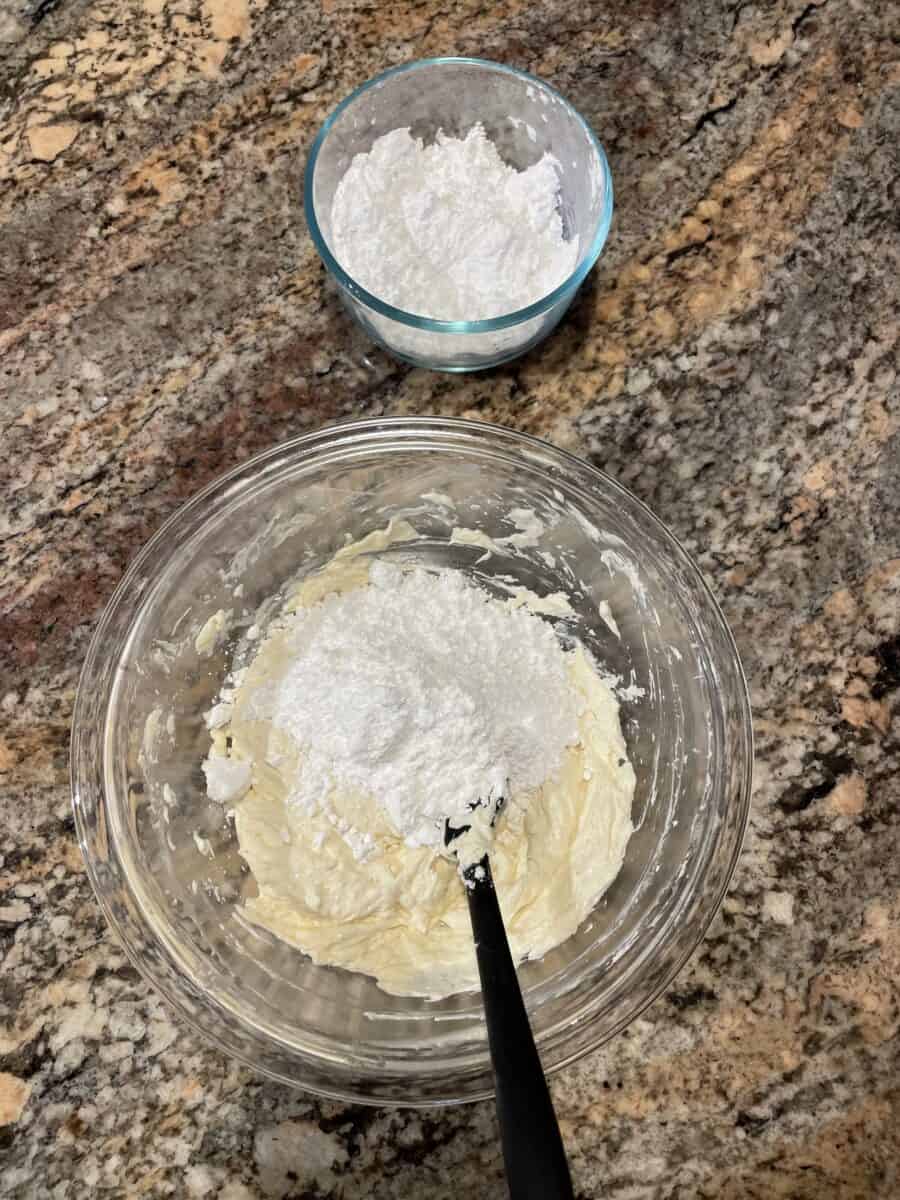 Adding Powdered Sugar to the Cream Cheese Mixture in a Bowl.