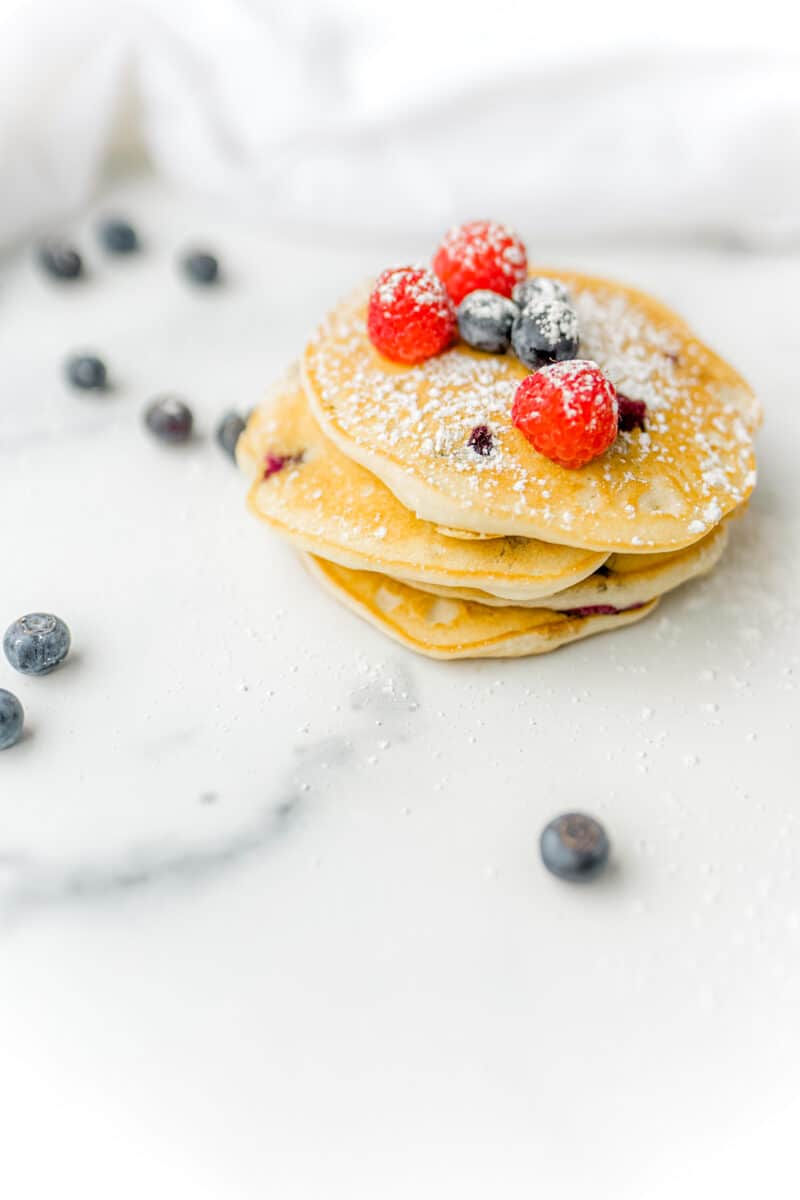 Griddle Pancakes Made with Fresh Blueberries Stacked on a Table.