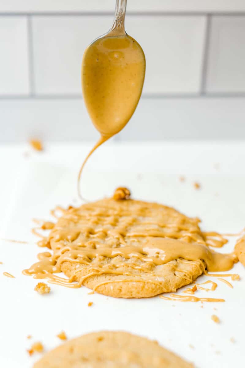 Drizzling Melted Peanut Butter Overtop a Homemade Peanut Butter Cookie.