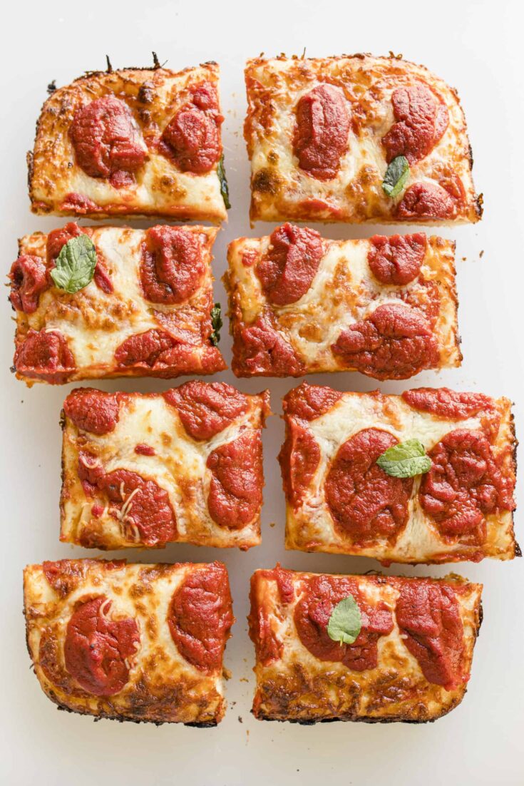 A Detroit Style Pizza that has been cut into rectangle pieces.