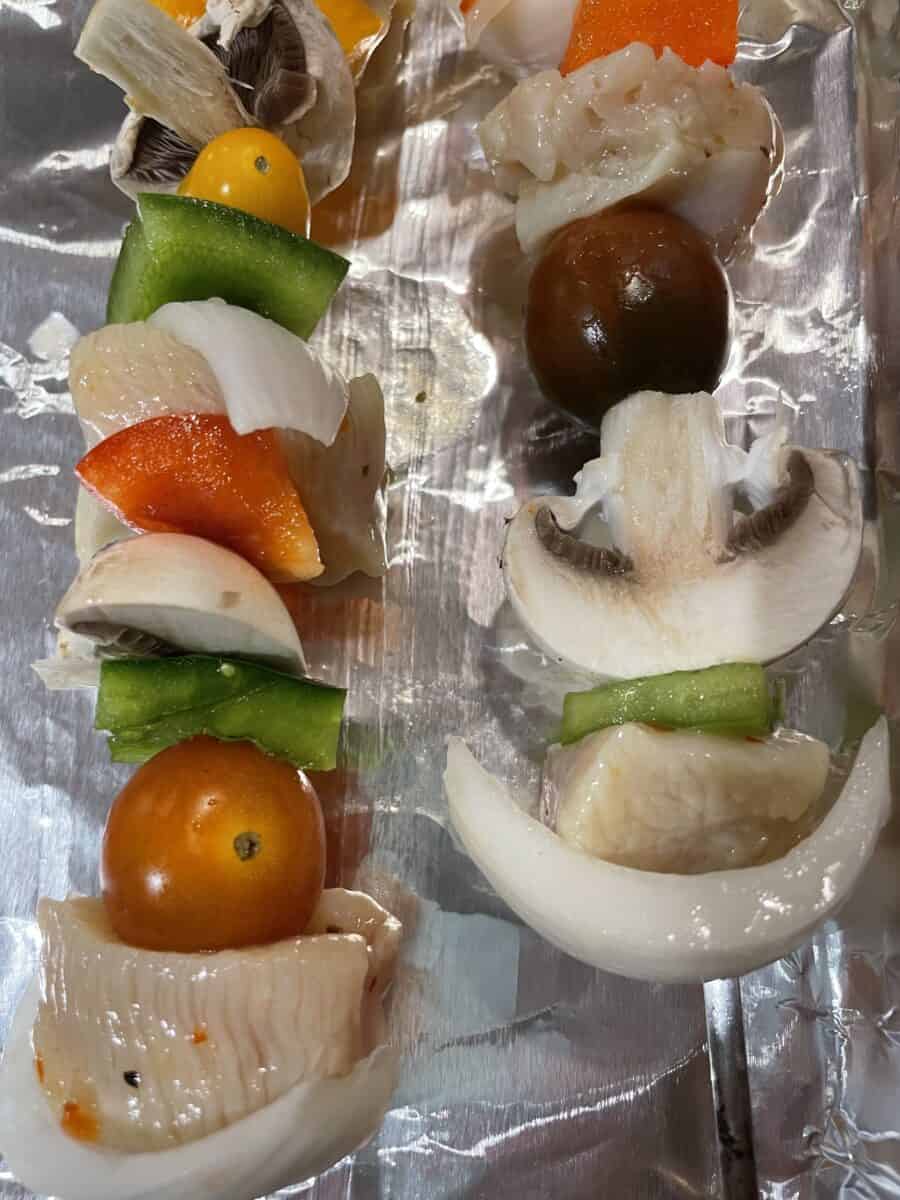 Assembled Uncooked Chicken and Vegetable Kabobs.