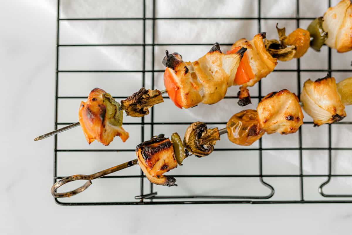 Smoker Chicken Kabobs with Vegetables on a wire rack.