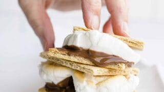 A Hand Holding a Stack of Smores made in the Blackstone Pizza Oven.