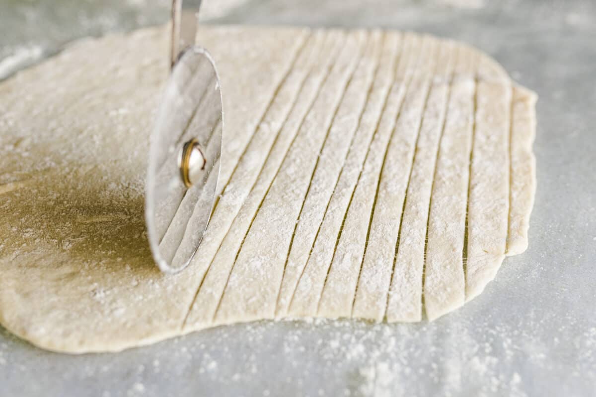 Cutting the Italian Breadstick Dough with a Pizza Cutter. 