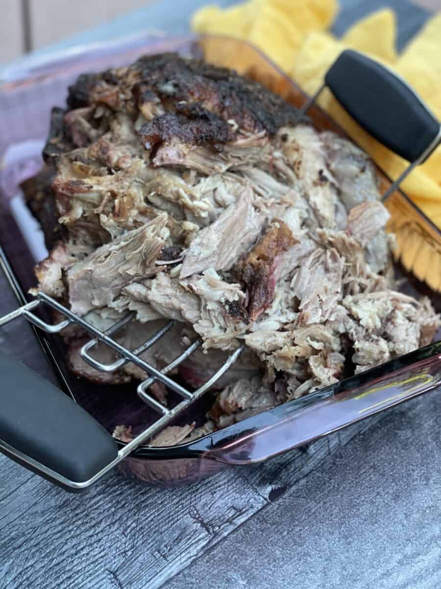 Using a Meat Claw to Shred the Smoked Pork.