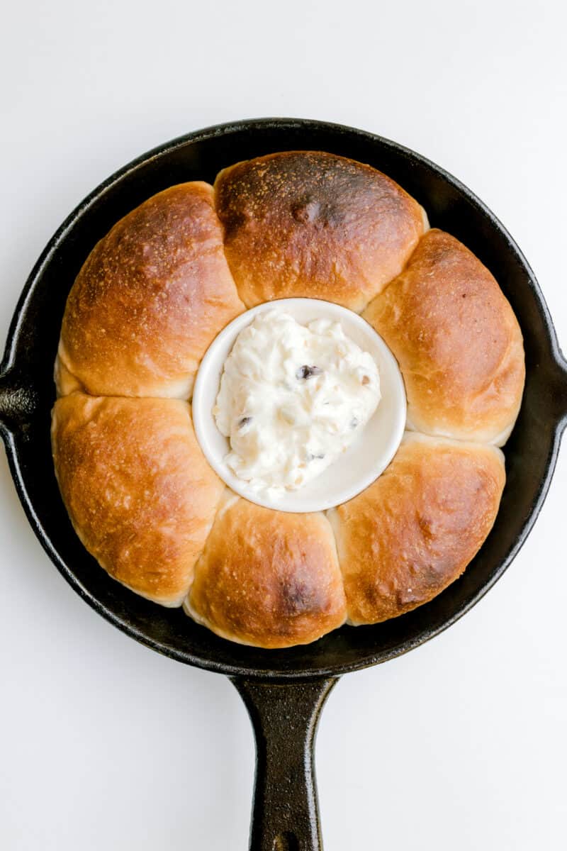 Cast Iron Pan Yeast Rolls Recipe Served with a Bowl of Garlic Herb Butter.