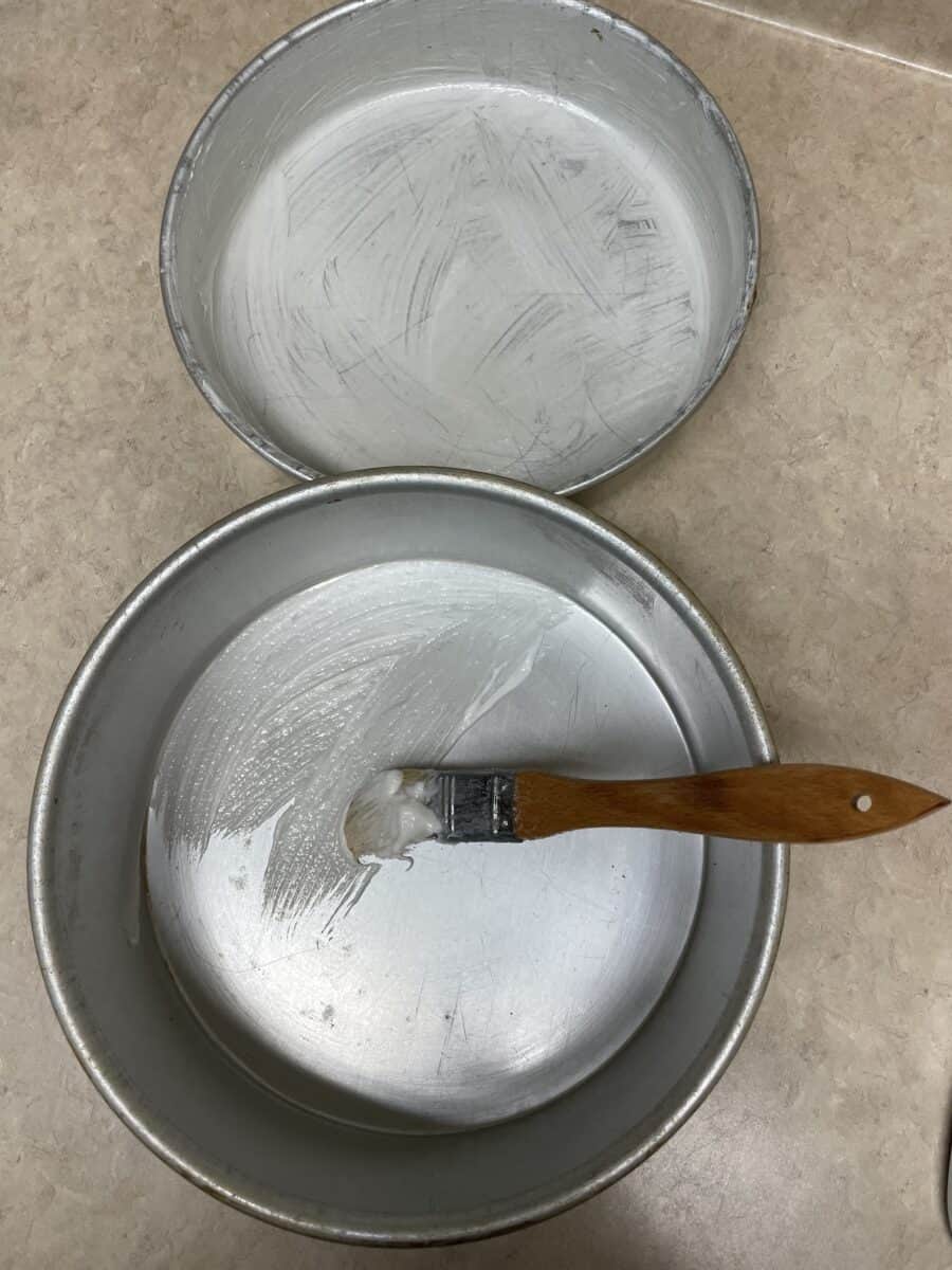 Coating the Inside of a Cake Pan with Pan Grease using a Pastry Brush.