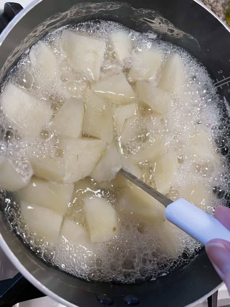 Testing the Boiled Potatoes for Doneness.
