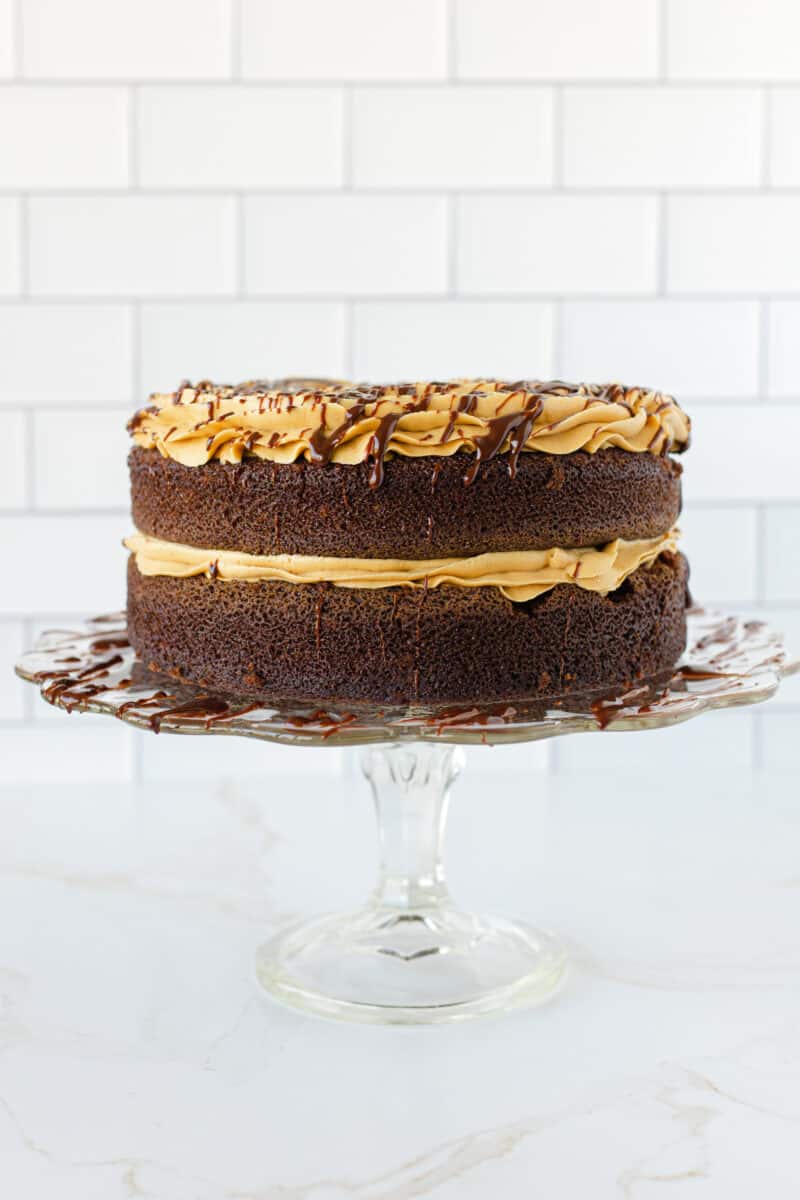 Crazy Cake Topped with Peanut Butter Frosting and a Drizzle of Chocolate Ganache.