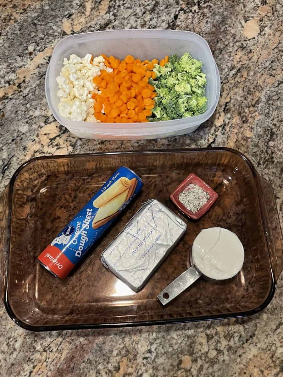Cold Vegetable Pizza Ingredients: Assorted Diced Vegetables, Can of crescent dough sheet, cream cheese, sour cream, and dill dip mix.
