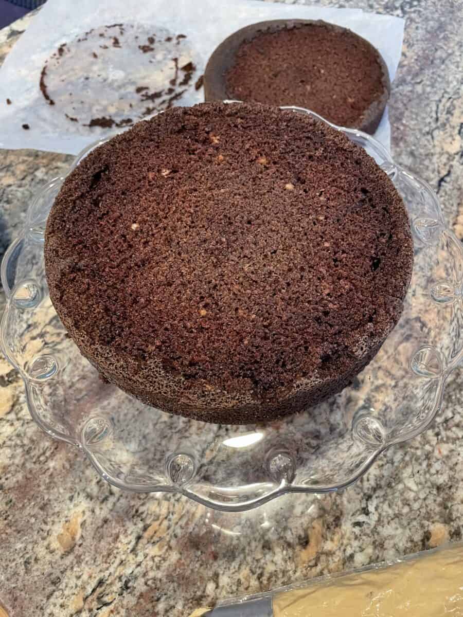 A Chocolate Cake Layer on a Glass Cake Stand.