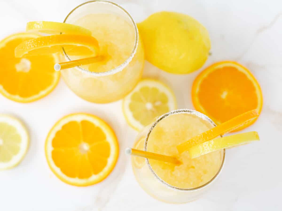 Whiskey Slush Recipe in a glass garnished with orange and lemon slices.