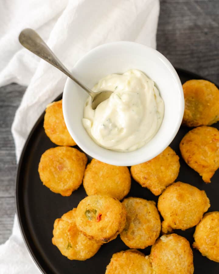 Best Tartar Sauce Recipe in a serving dish surrounding by crab bites.