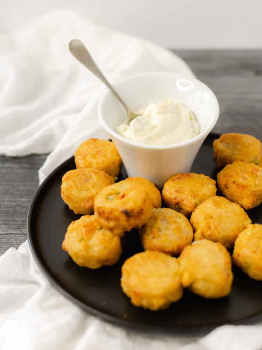 Easy Tartar Sauce Recipe in a serving dish surrounding by crab bites.