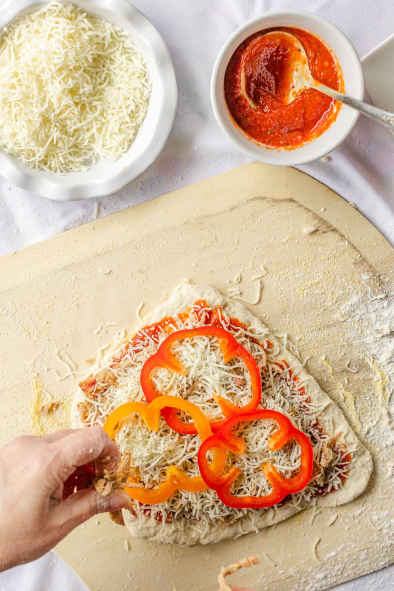 Garnish the Top of the Pizza with Bell Pepper Rings.