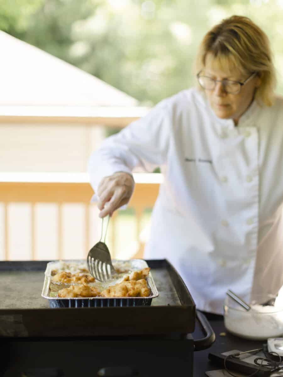 Chef Sherry Ronning Deep Frying Banana Fritters on a Blackstone Griddle.