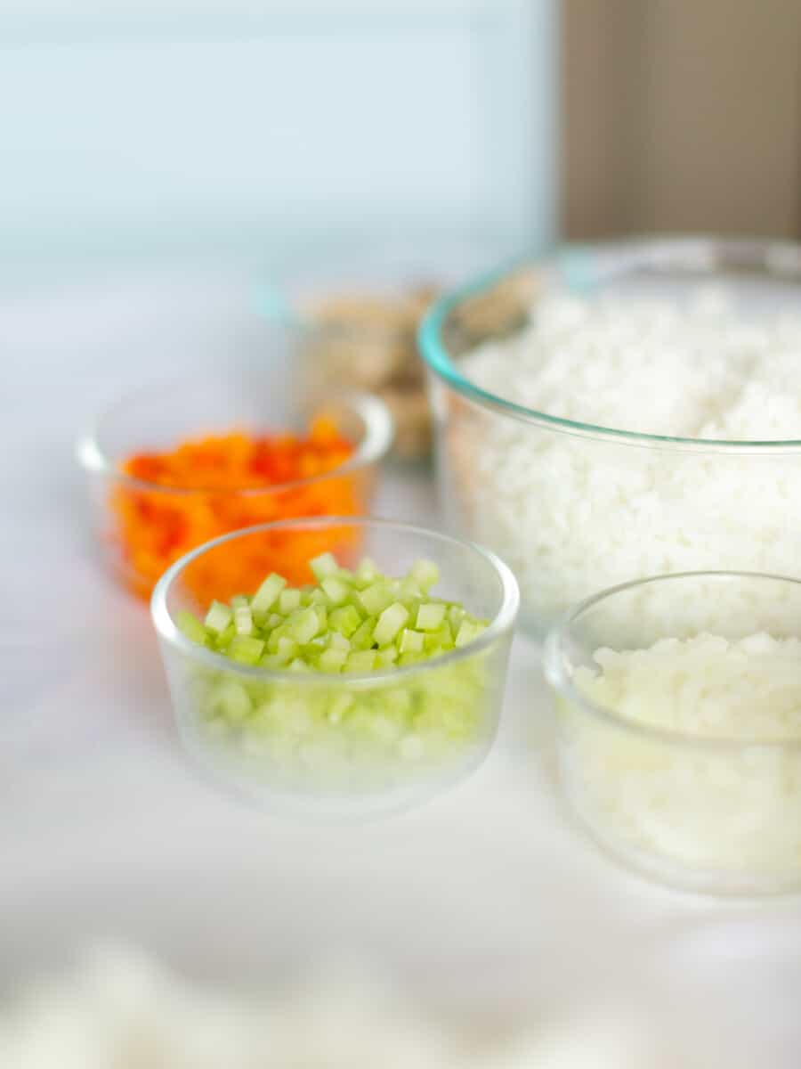 An Assortment of Fried Rice Ingredients: Cooked White Rice, Diced Celery, Peppers, Onions, and Mushrooms.