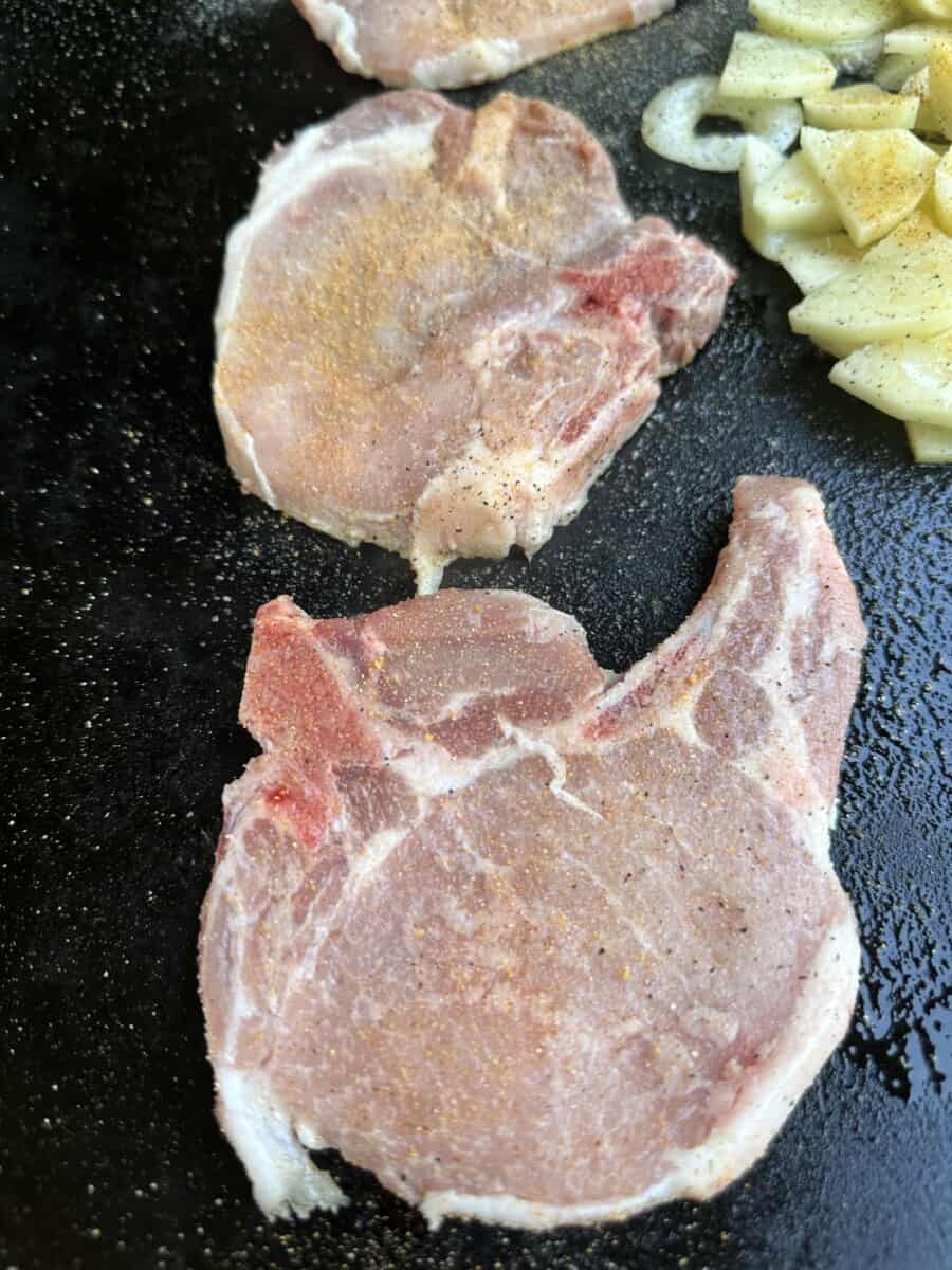 Place Seasoned Pork Chops onto the Hot Blackstone Griddle