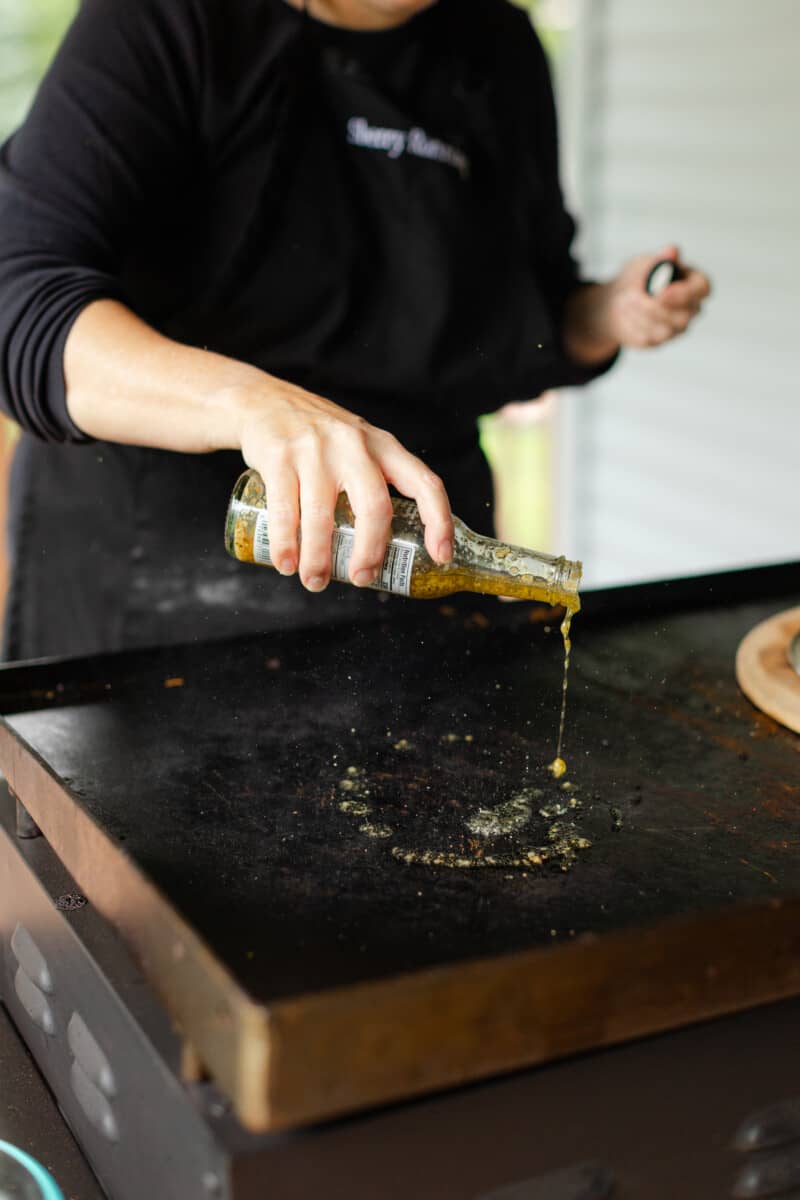 Adding Olive Oil with Garlic and Parmesan to the Hot Griddle