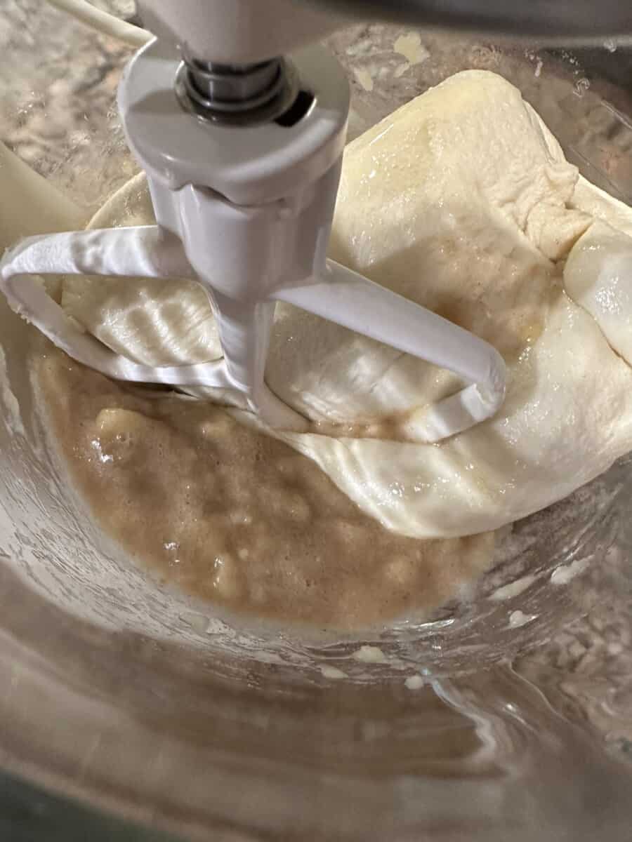 Adding Bread Dough to the Mashed Banana Mixture in a Mixing Bowl.