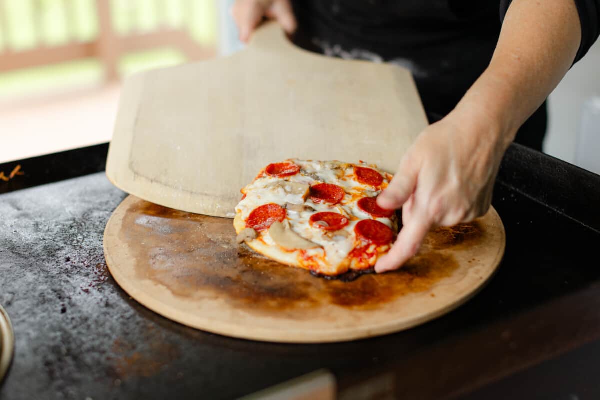 Removing the Blackstone Pizza with a Wooden Pizza Peel.