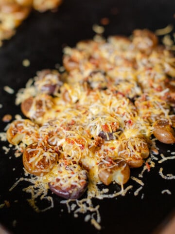 Crispy Cheese and Bacon Smashed Potatoes on Blackstone Griddle.