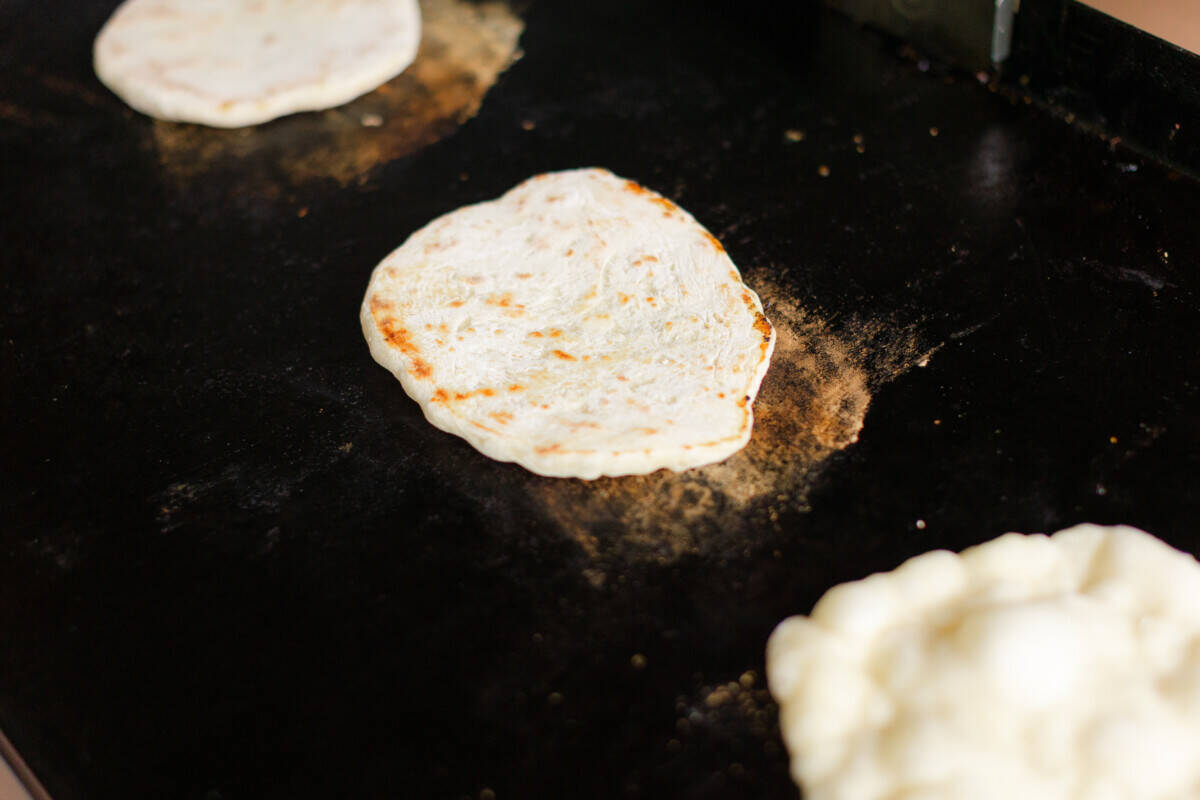 Naan Dough Cooking on a Blackstone Griddle