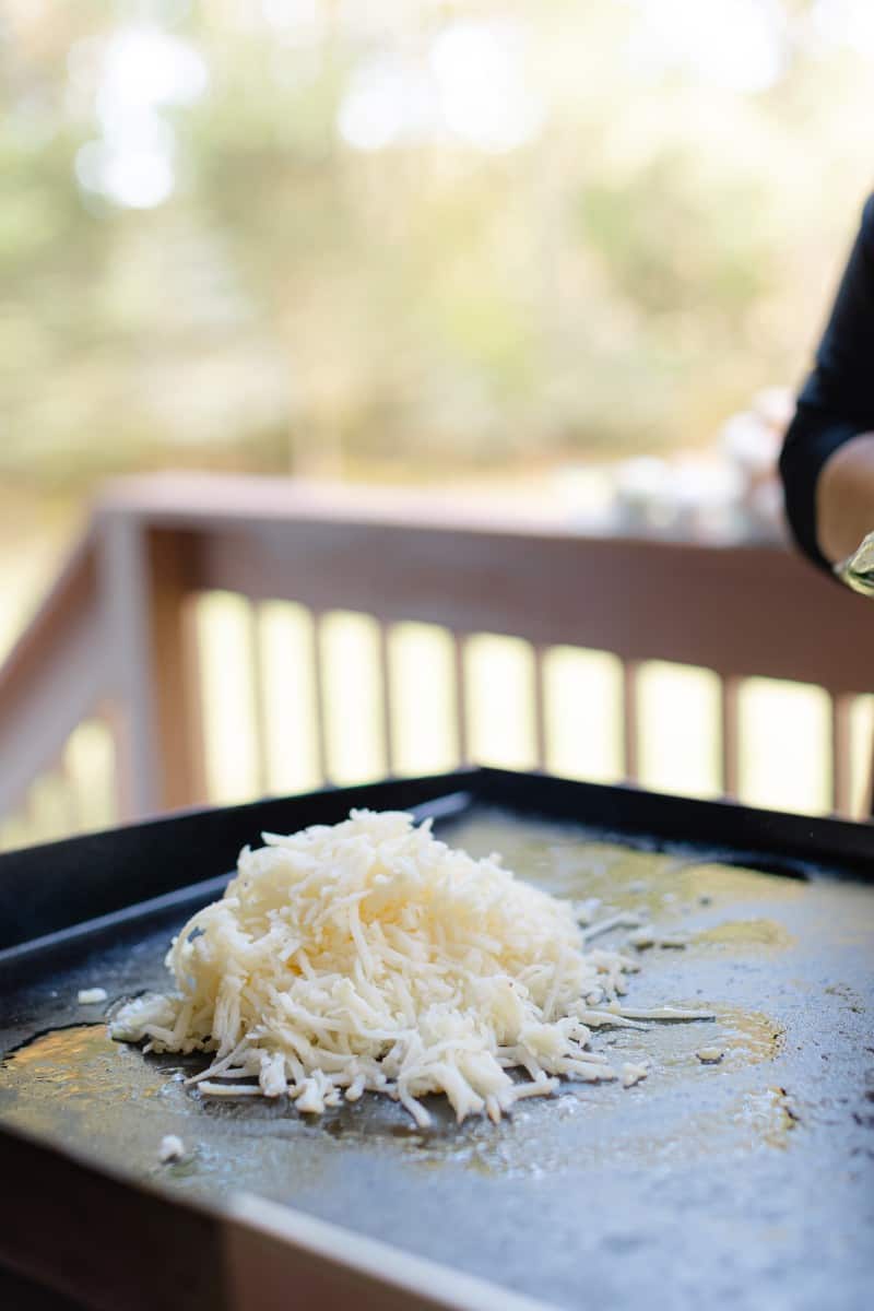 A Mound of Fresh Shredded Hash Browns to a Griddle.