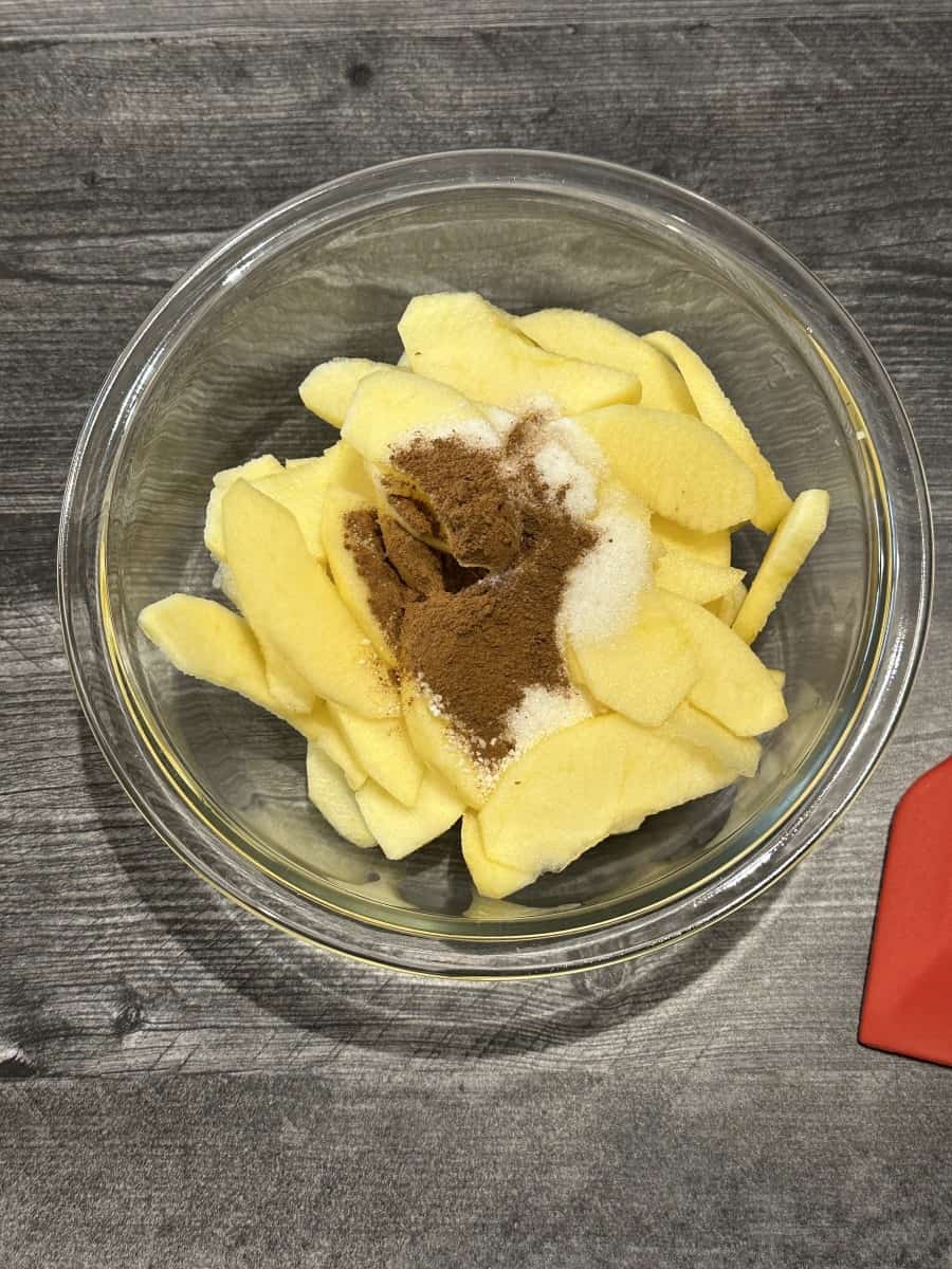 Dry Ingredients on top of Sliced Apples in a Bowl