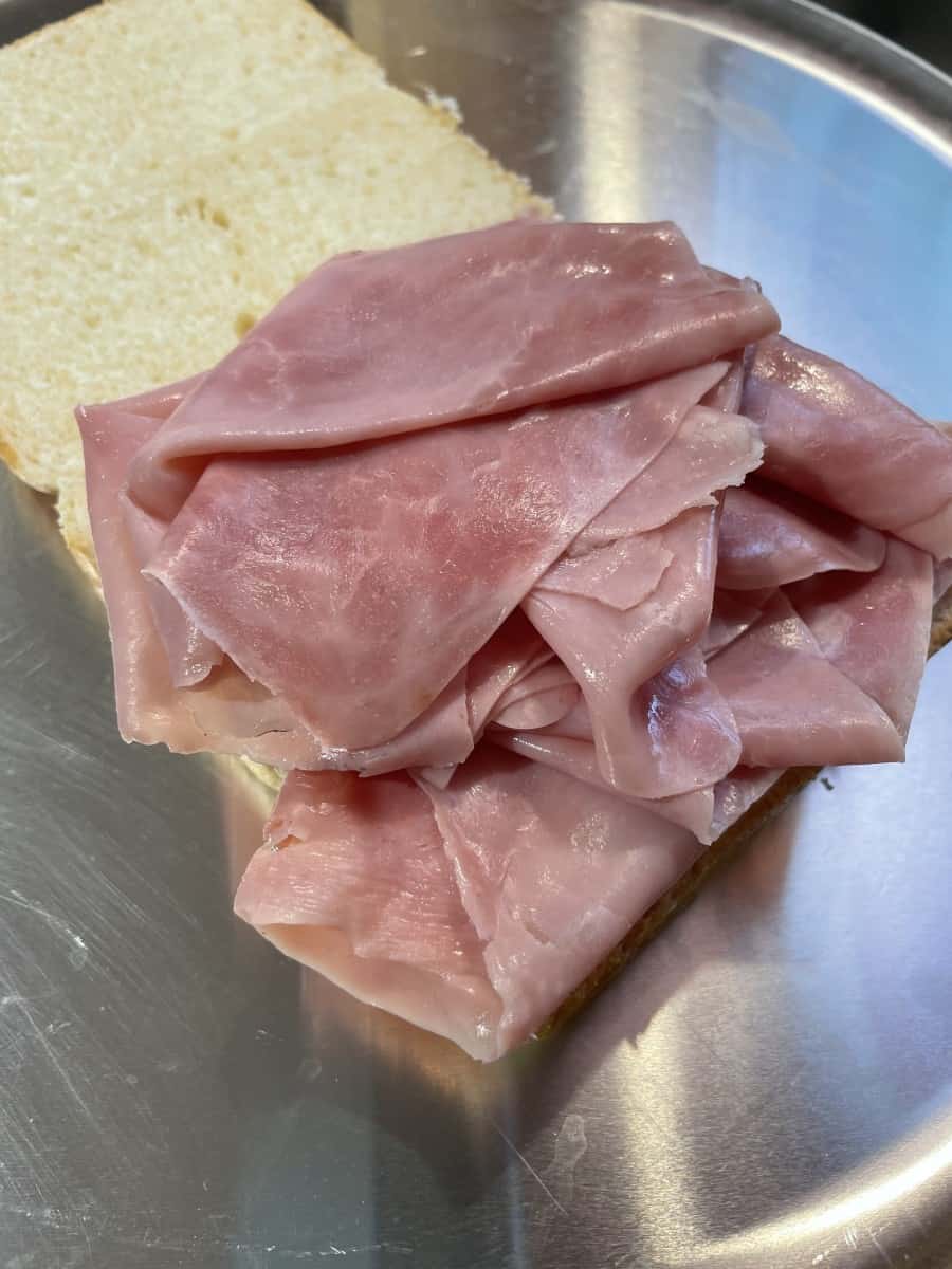 Add Layers of Thin Ham onto the Bottom Half of Rolls.