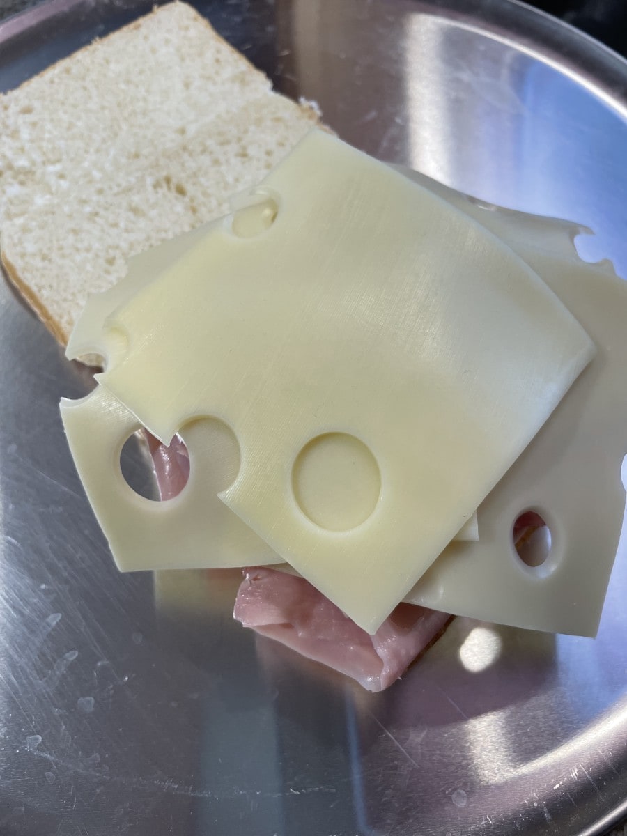 Place Slices of Swiss Cheese onto the Ham Slices.
