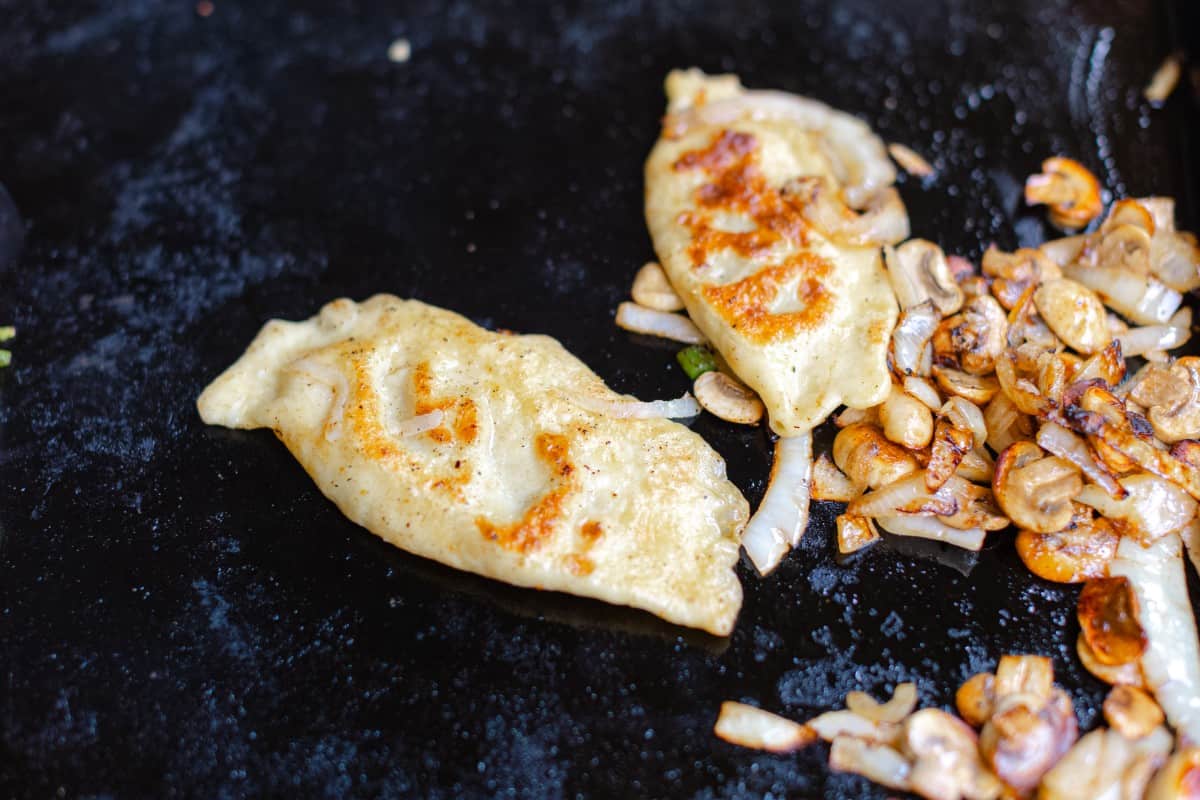 Caramelized Onions and Mushrooms with Cabbage Pierogies on a Blackstone Griddle
